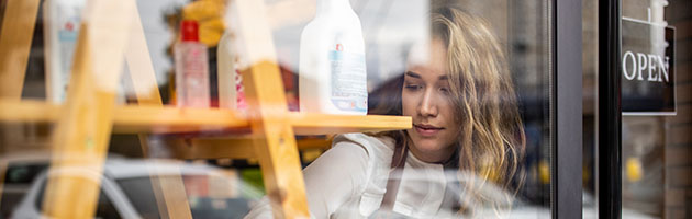 Shop window with a young lady looking out