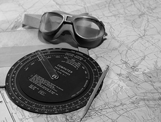Photo showing an old map and flying goggles