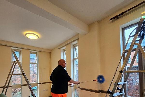 Cleaning the community room before the painting begins