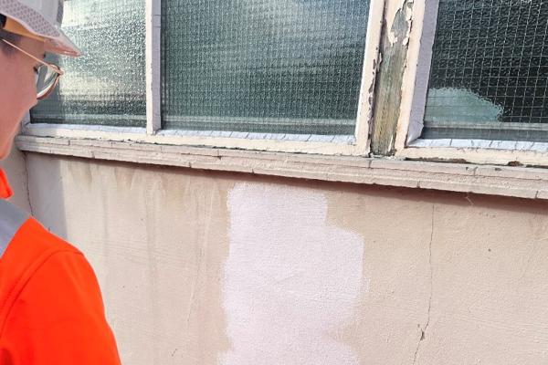 A volunteer painting the wall