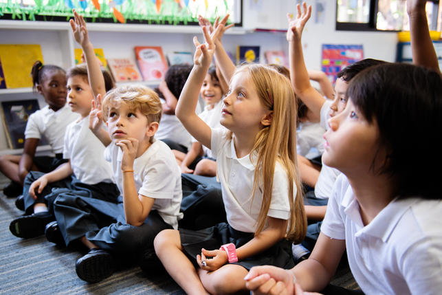 Children at school sitting on the carpet
