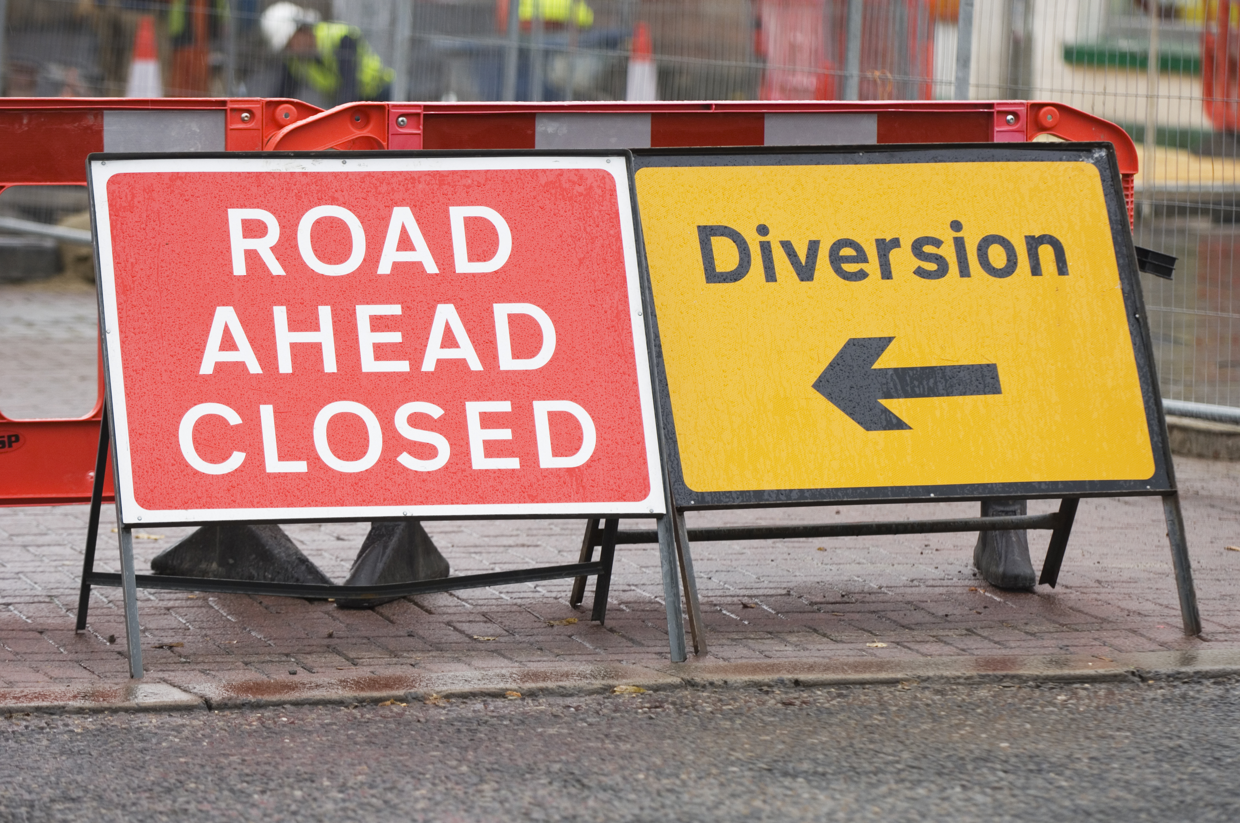 Road ahead closed and diversion signs next to some roadworks