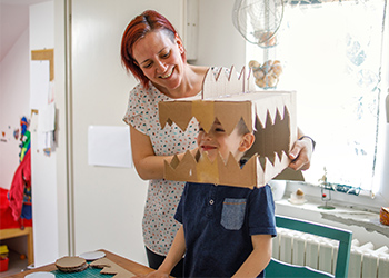 Smiling mother playing with her son