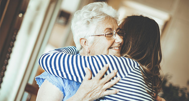 Senior woman is embracing her daughter