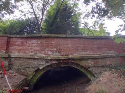 Crack on side of road over bridge