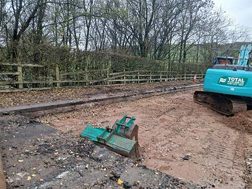 Digger with road levelled away