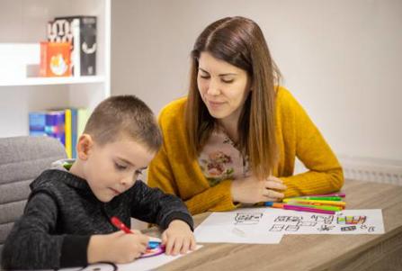 Boy with teaching assistant