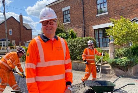 Councillor Goldsmith with  highways operatives repairing a road