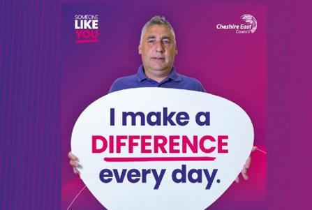 Social worker holding a placard which reads "I make a difference every day"