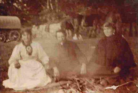 Three women in a camp