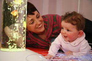 Mother and child look at a sensory bubble tube