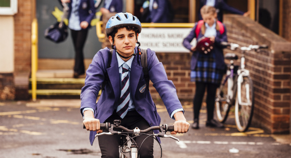 Boy cycling to school