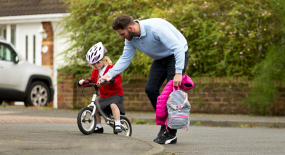 Child cycling to school 570x310
