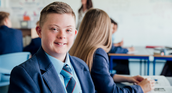 Down syndrome teenage boy during a lesson 570 x 310