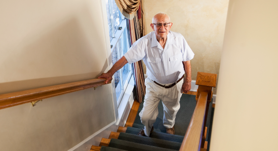 Falls prevention awareness 2023 Senior man climbing staircase