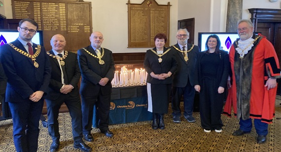 Holocaust Memorial Day dignitaries gather around commemorative candles