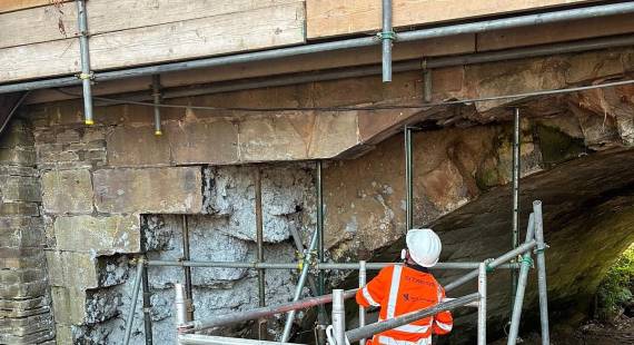 An engineer surveys Mill House Bridge during repair works