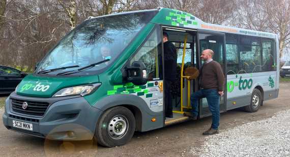 Passengers boarding go-too bus service