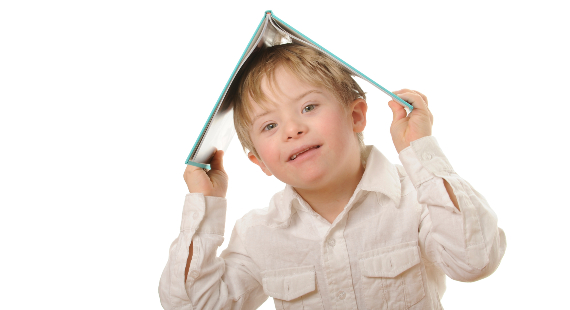 Child with disabilities holding a book or a strategy