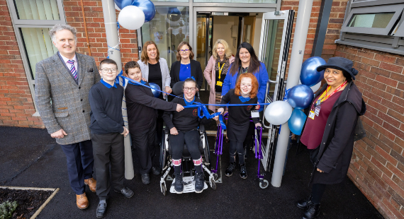 Pupil and staff cut the ribbon at the official opening of Springfield School in Wilmslow