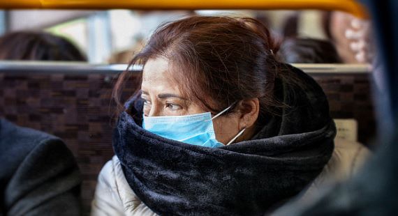 Woman on bus in mask 570 x 310