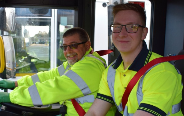 Image of driver and loader in a waste vehicle